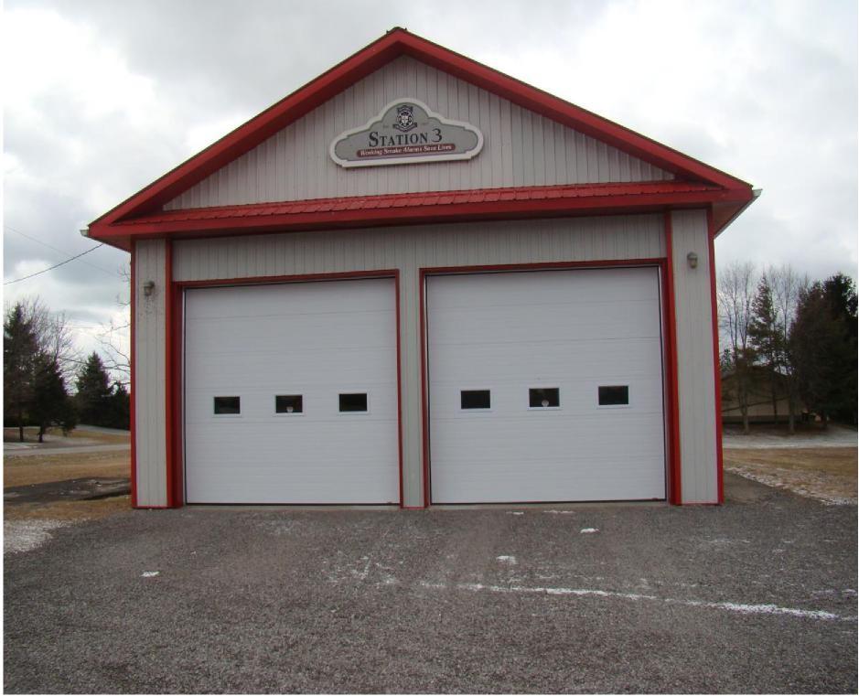 Fire Station 3 building with two white garage doors and a red-trimmed roof.
