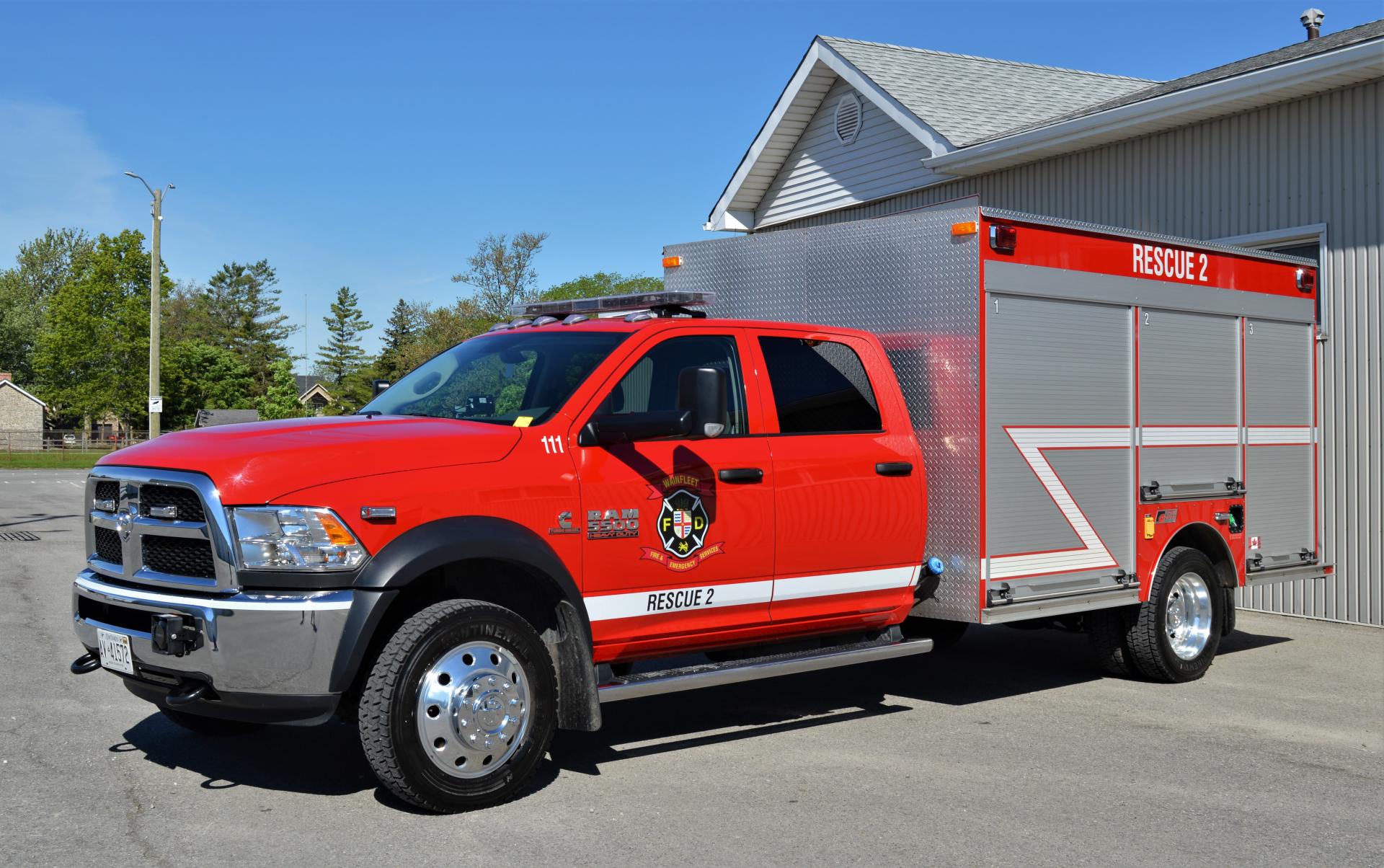 Red Dodge Ram 5500 marked Rescue 2 with Wainfleet Fire Department logo, parked outside.