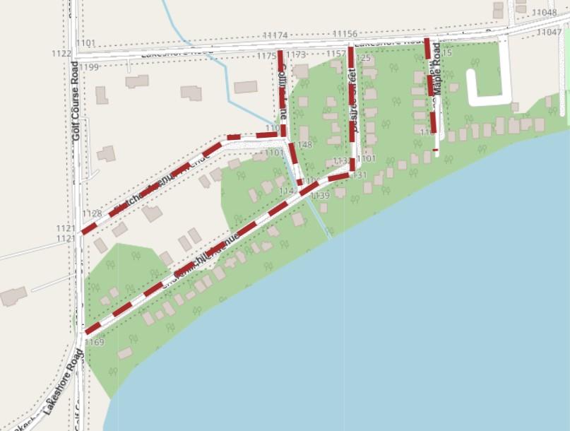 Map showing a residential area near a body of water, with streets marked in red and white. Roads include Golf Course Road, Lakeshore Road, and multiple smaller streets such as Tyler, Baldwin, and Maple.